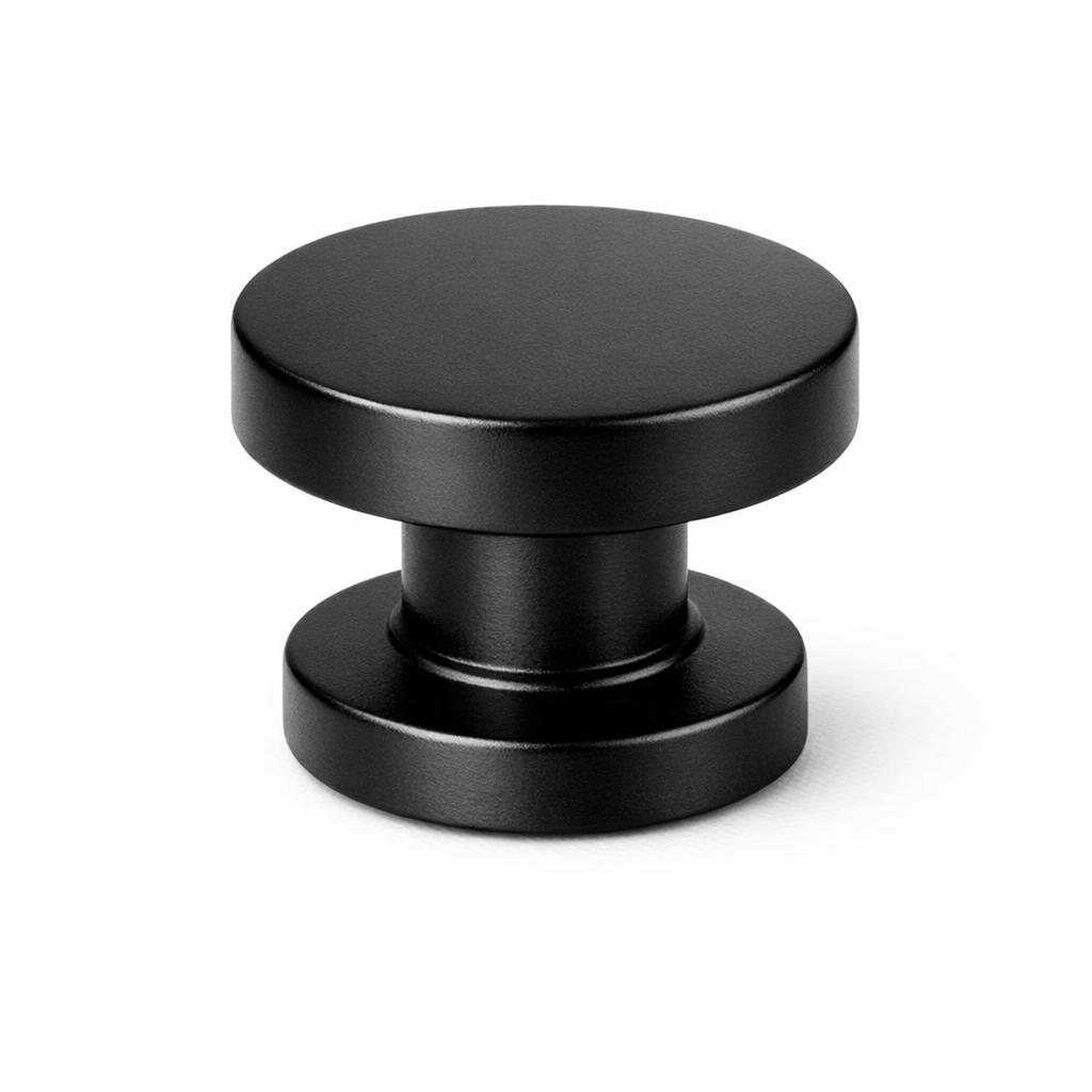 Commercial product photograph. A single residential cabinet knob. Smooth surface texture. Round Knob shape. Matte Black metal finish. Small circular base plate, single mounting post, approximately 1-1/4 inch diameter. Photographed on pure white seamless background (#FFFFFF). Studio softbox lighting, soft shadow directly underneath only. Macro lens, sharp focus throughout. Photorealistic real metal hardware. Not a 3D render. Not an illustration. Not CGI. Real cabinet hardware product photography quality. Variation 4: Cadet style cabinet knob: two-tier stacked cylinder, a flat disc top, a narrower straight cylindrical neck, then a wider cylindrical base, three distinct stepped levels. Smooth surface, no texture, no ribbing, no decorative details..