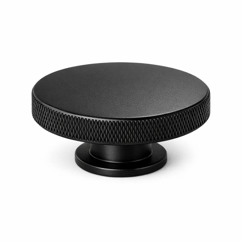 Commercial product photograph. A single residential cabinet knob. Knurled surface texture. Round Knob shape...