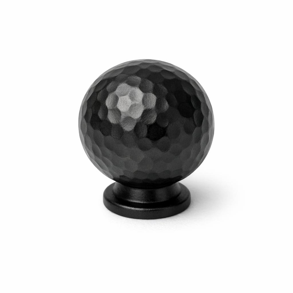 Commercial product photograph. A single residential cabinet knob. Hammered surface texture. Round Kn