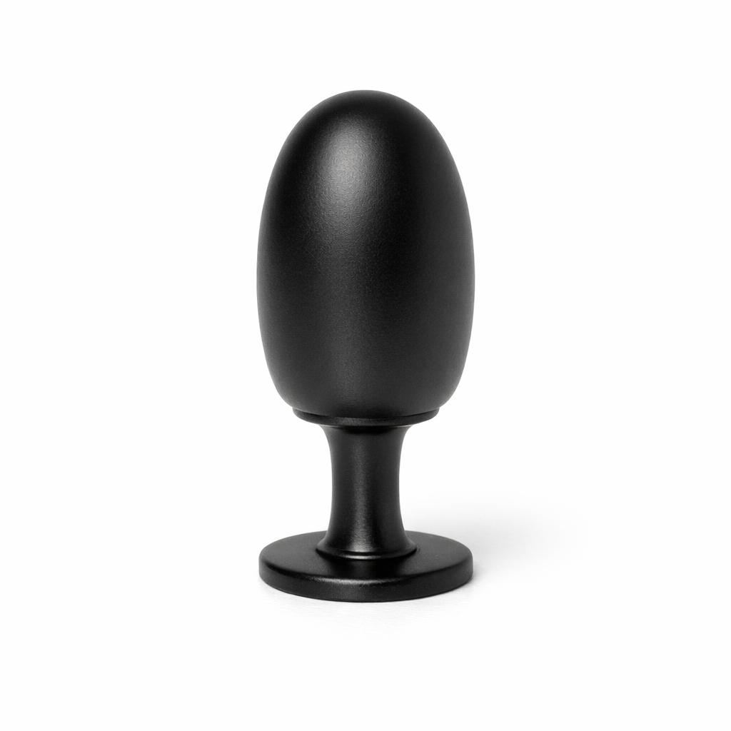 Commercial product photograph. A single residential cabinet knob. Smooth surface texture. Round Knob shape. Matte Black metal finish. Small circular base plate, single mounting post, approximately 1-1/4 inch diameter. Photographed on pure white seamless background (#FFFFFF). Studio softbox lighting, soft shadow directly underneath only. Macro lens, sharp focus throughout. Photorealistic real metal hardware. Not a 3D render. Not an illustration. Not CGI. Real cabinet hardware product photography quality. Variation 3: Tall elongated dome top, thin stem, small base plate.