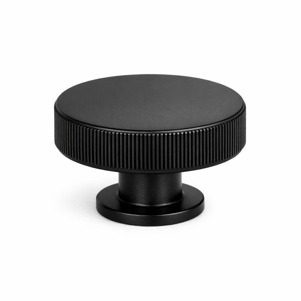Commercial product photograph. A single residential cabinet knob. Knurled surface texture. Round Knob shape...